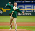 Scottie Scheffler used his Masters green coat to toss out the veryfirst pitch at a Rangers videogame