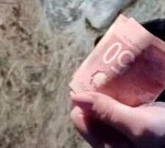 Somebody is hiding money all over a city in New Brunswick and homeowners are caring it