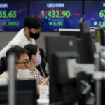 Asian stocks sink on German inflation, British tax cuts