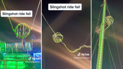 View: Teenagers left hanging high above crowd after slingshot trip breakdowns