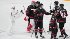 Camouflaged cameraman mixes in while being front and centre at world juniors