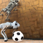 A four-legged robotic system capable of playing soccer on a range of surfaces