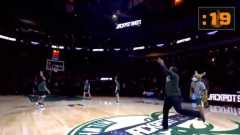 The just pleased Bucks fan is the one who hit a halfcourt shot to win $10,000