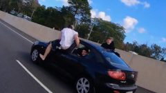 Wannabe stuntman attempts air-walking out of moving carsandtruck on Aussie highway