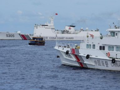 Philippine boats breach a Chinese coast guard blockade in a faceoff near a challenged shoal
