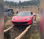 Brave owner tiptoes Ferrari 458 over world’s sketchiest bridge