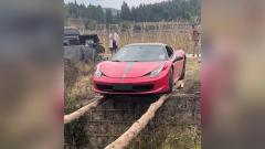 Brave owner tiptoes Ferrari 458 over world’s sketchiest bridge