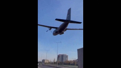 Turkish military airplane buzzes right over streets, field