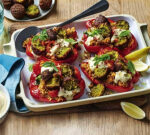 Courtney Roulston makes a enjoyable household supper, packed capsicums filled with rice, hommus and falafel