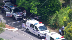 Two people, including a police officer, injured in Annerley shooting