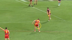 Suns midfielder Bailey Humphrey gives away 50-metre penalty throwing ball of mud at Jarrod Berry
