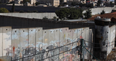 ‘I lost both legs’: Palestinians scale separation wall for chance to work