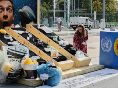 People climb buildings and hand out soap to push for a plastic pollution treaty