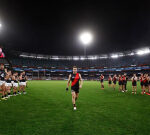 Inspirational Essendon skipper Zach Merrett plays with ‘six holes drilled into his hand’