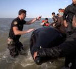 BBC on French beach as police slash migrant ‘taxi-boat’ heading to UK