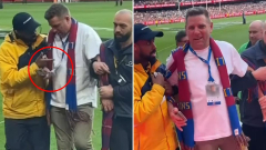 Imposter wearing ex-player’s accreditation arrested after joining AFL grand final celebrations