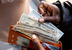 Dollar falls ahead of data releases, risk of US government shutdown looms