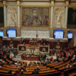 Political crisis in France eases for now as prime minister survives no-confidence vote