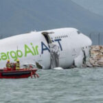 A cargo aircraft skids off a Hong Kong runway into the sea, killing 2 airport workers