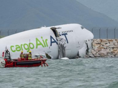 A cargo aircraft skids off a Hong Kong runway into the sea, killing 2 airport workers