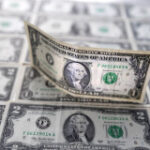 Dollar holds near three-month peak ahead of US data releases