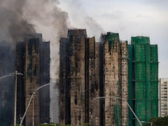 At least 55 dead as Hong Kong firefighters battle burning towers for a second day