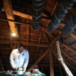 A traditional sausage in the shape of a horseshoe is ‘ironed’ for dryness in southeastern Serbia