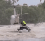 Hero helicopter pilot saves men and dog from floodwaters in dramatic rescue near Katherine, NT